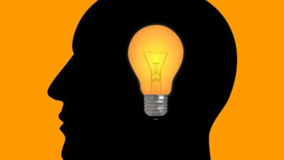 Important business terms for entrepreneurs illustrated by a human head silhouette with a lightbulb