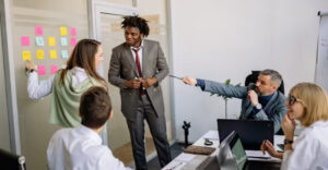 Startup life cycle stages illustrated by a team planning and collaborating in an office