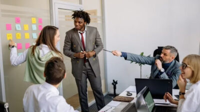 Startup life cycle stages illustrated by a team planning and collaborating in an office