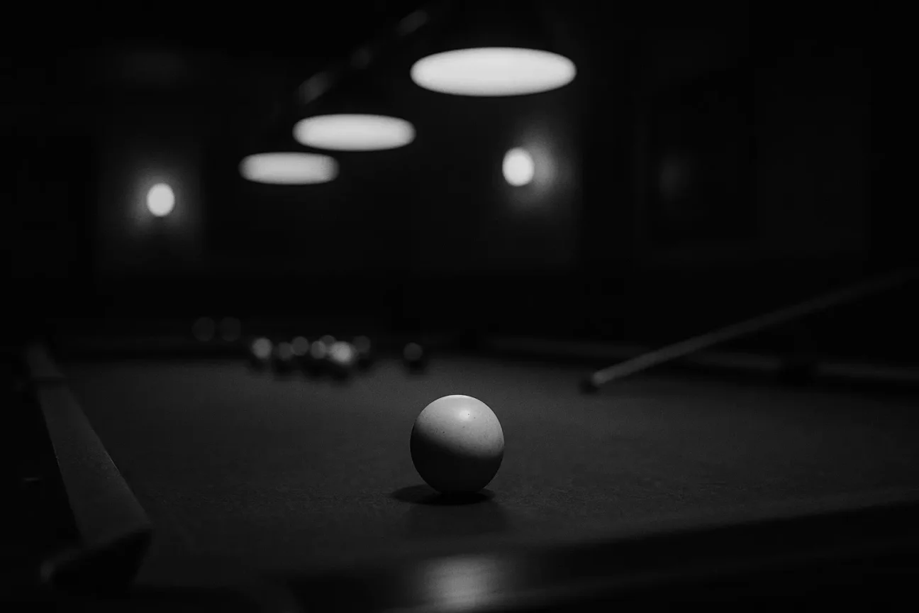 Black-and-white cinematic photo of a pool table with a cue ball in focus, symbolizing late-night conversations with my mentor Steve that shaped my journey.