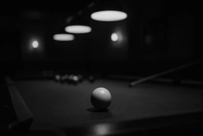 Black-and-white cinematic photo of a pool table with a cue ball in focus, symbolizing late-night conversations with my mentor Steve that shaped my journey.